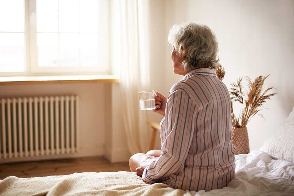 Caregiving Older Woman Suffering From Alzheimer's Disease